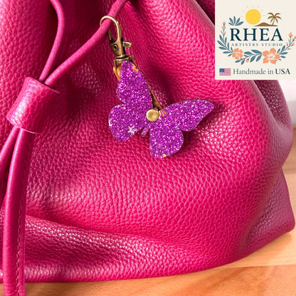 Pink textured bag with a purple glittery butterfly charm, Rhea Artistry Studio 