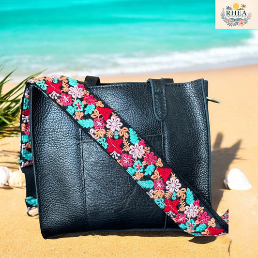  Embroidered strap with vibrant clustered florals in red, teal, and soft peach hues on a black woven background