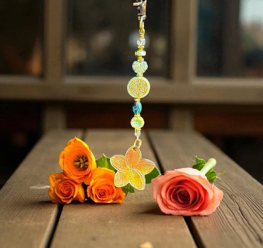 Decorative keychain with flowers on a wooden surface