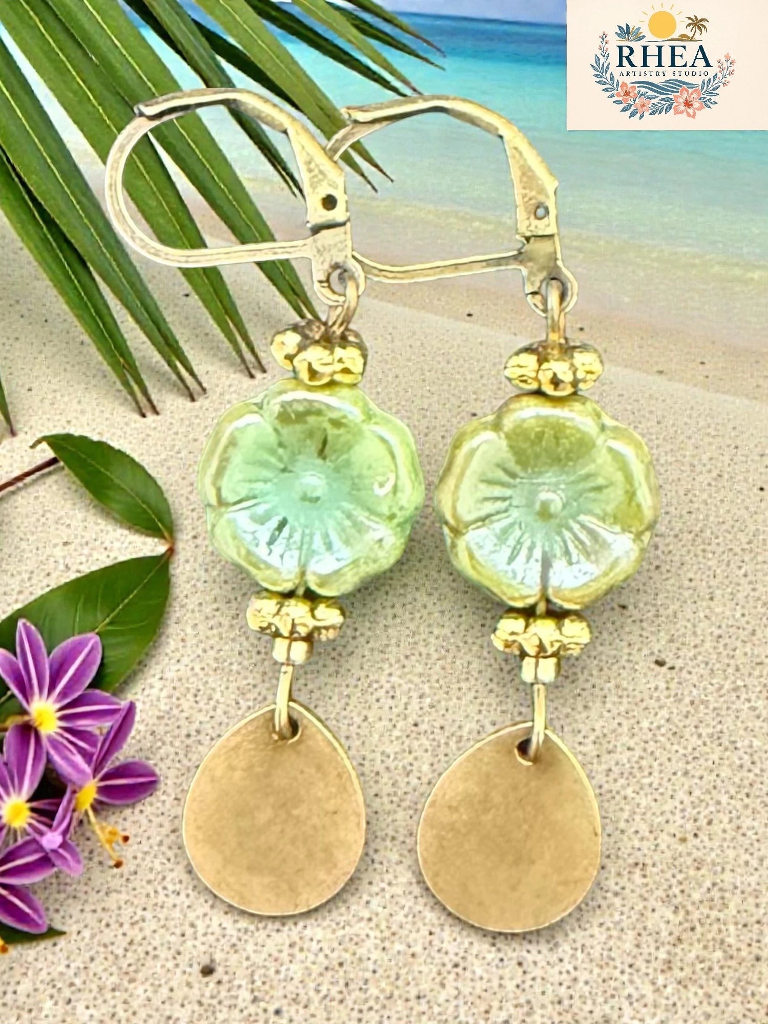 Handmade earrings showcasing fine beadwork and polished metal components in fern green