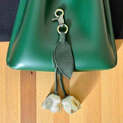 gold green tulip leather flower on a green hand bag