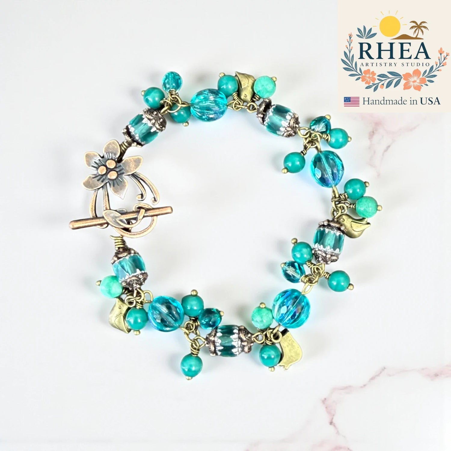 Ocean Bloom Bracelet handmade with Czech glass beads, turquoise gemstones, and brass floral details — artisan jewelry inspired by the sea and sky.