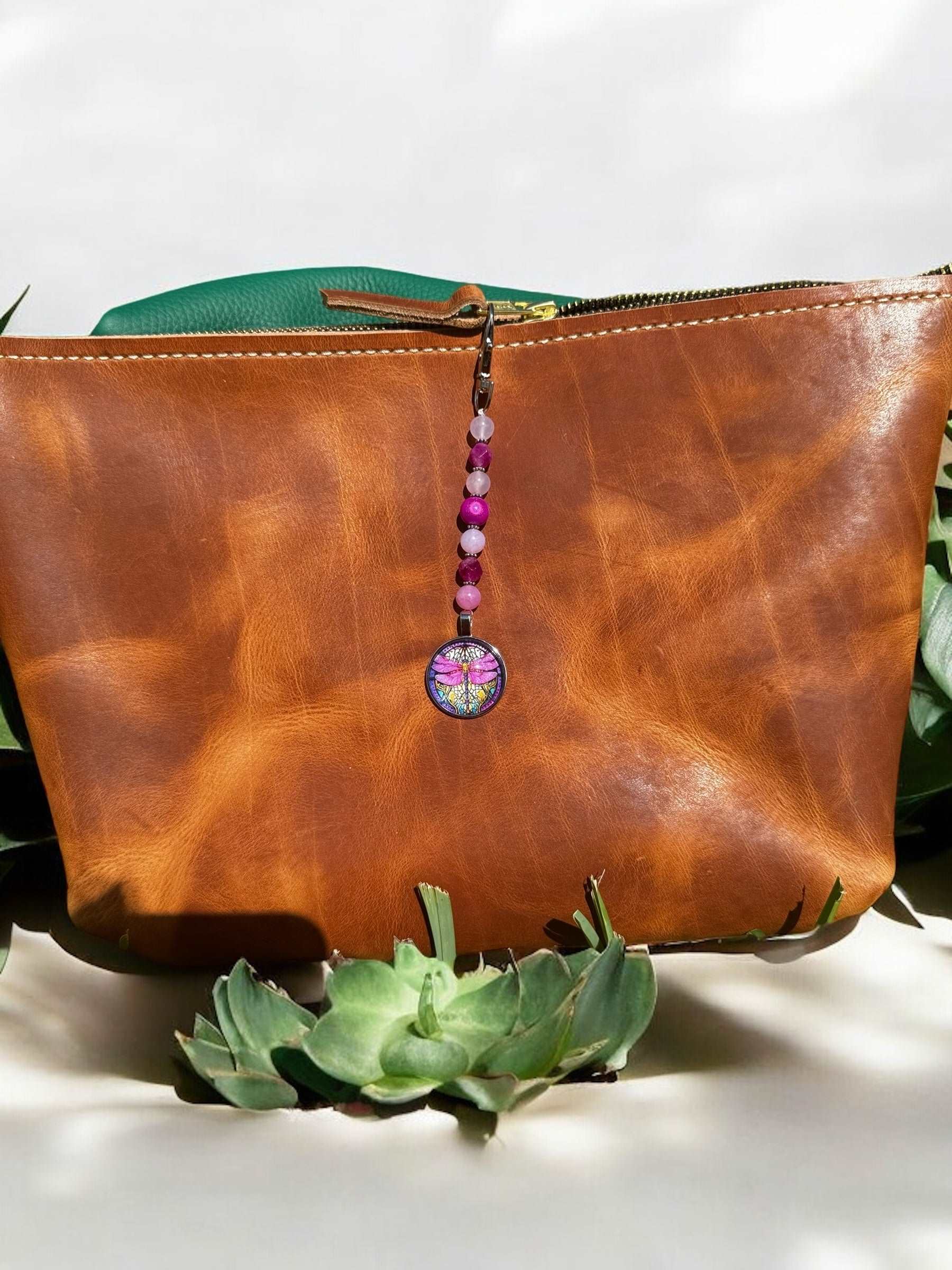 image of a purse with a pink beaded charm and hot pink dragon fly  as a pendant