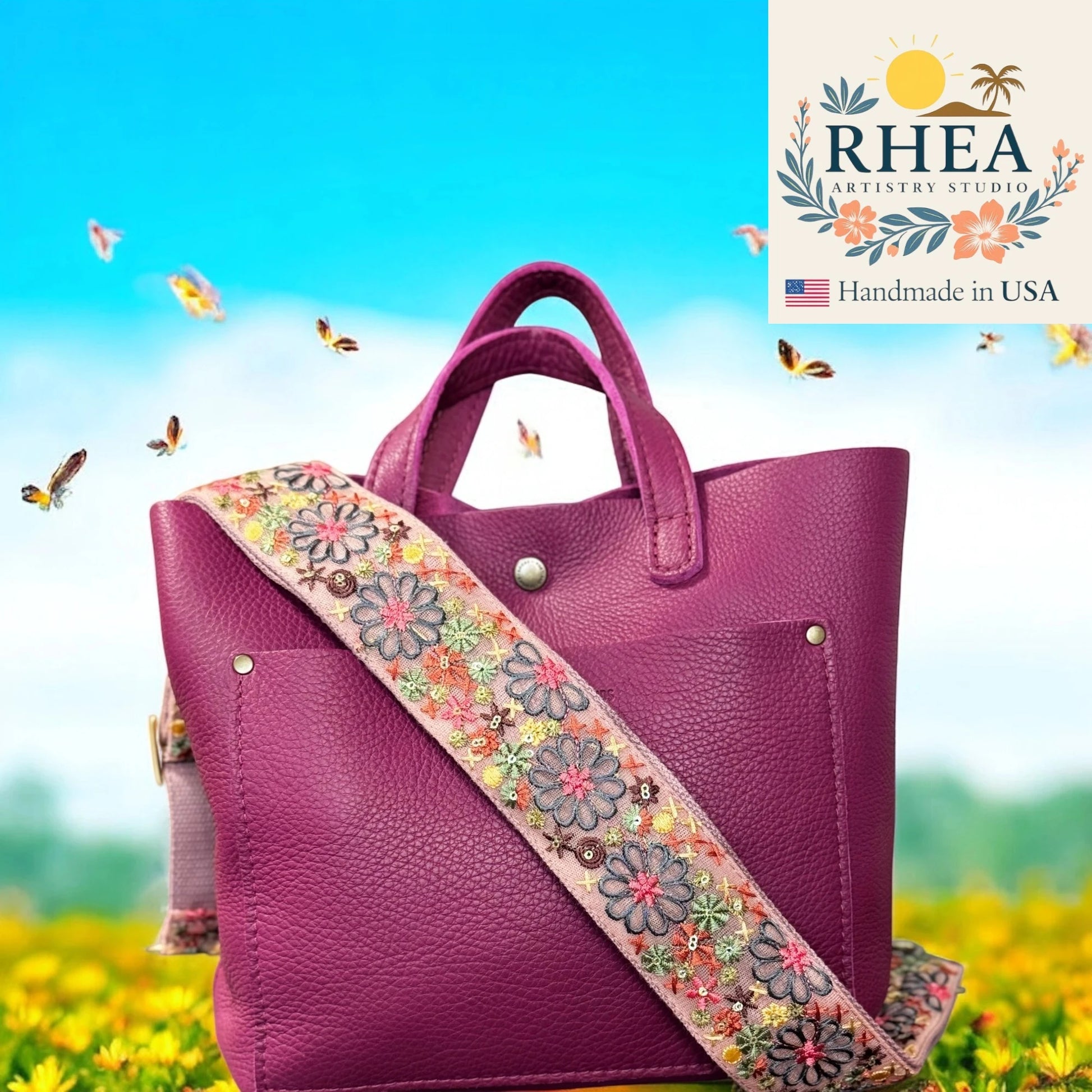 Purple handbag with a floral strap against a scenic background, featuring the RHEA Artistry Studio logo.