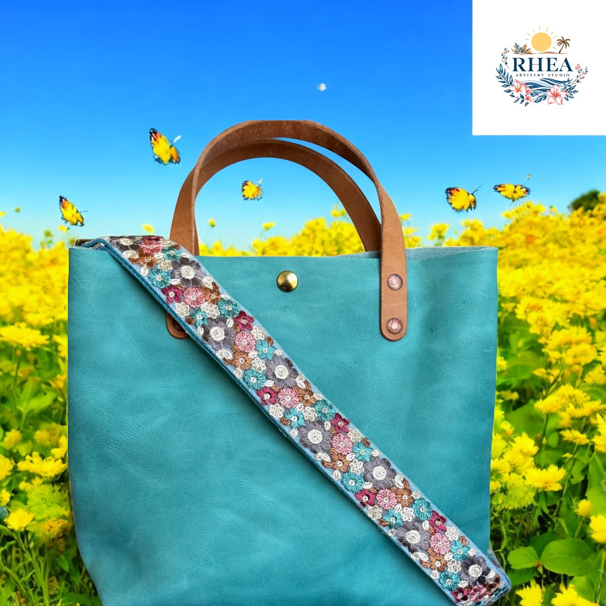 This Meadow Mosaic strap features a vibrant floral pattern on an aqua-blue base, accented with maroon, lavender, golden tan, and soft teal blooms. The combination of warm and cool tones creates a balanced, eye-catching design that adds a touch of artisanal charm to any bag. Perfect for spring and summer styling, this strap brings a fresh, meadow-inspired palette to your accessories.