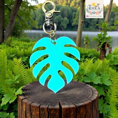 Lightweight monstera mini charm attached to bag zipper
