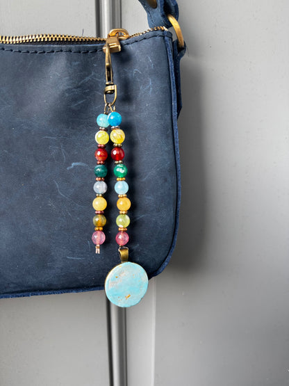 multi colored beaded on 2 strands with a handmade colorful pendant with lobster clasp