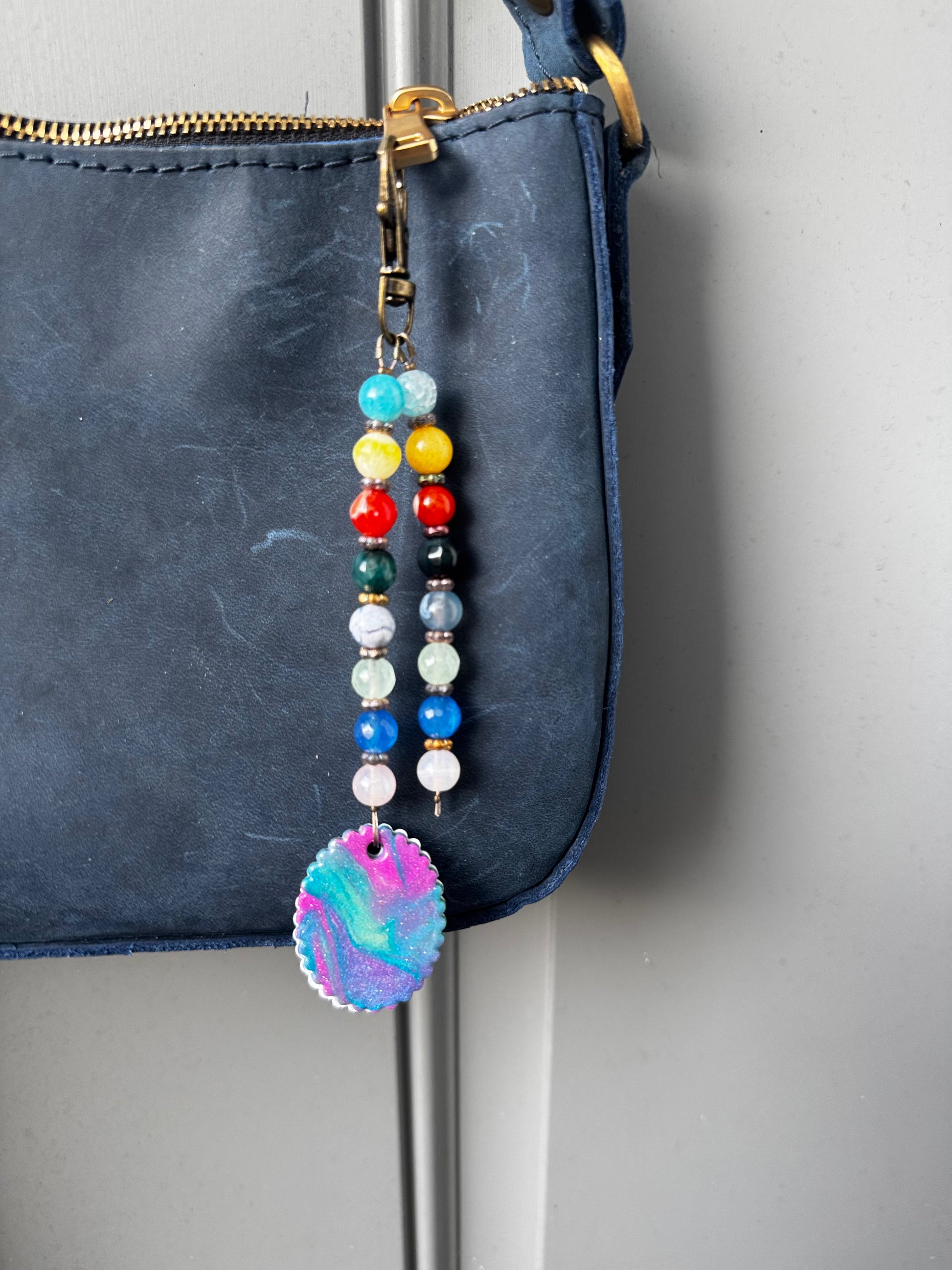 multi colored beaded on 2 strands with a handmade colorful pendant with lobster clasp