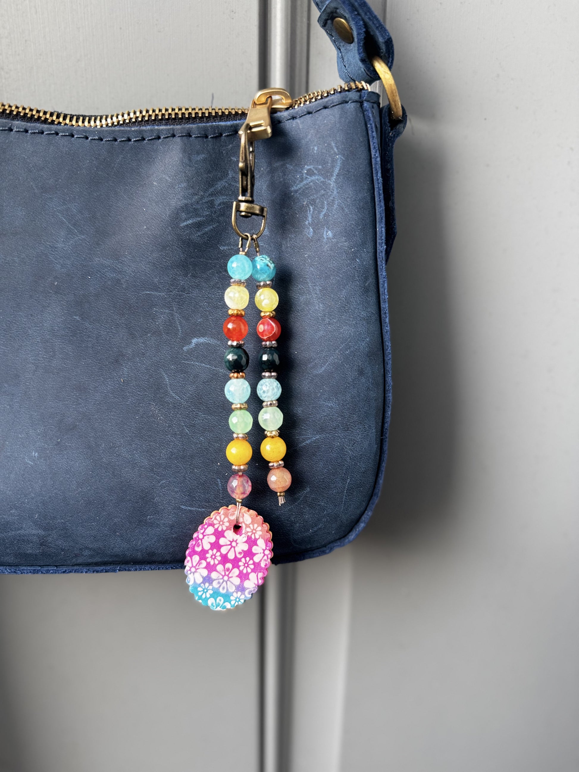 multi colored beaded on 2 strands with a handmade colorful pendant with lobster clasp