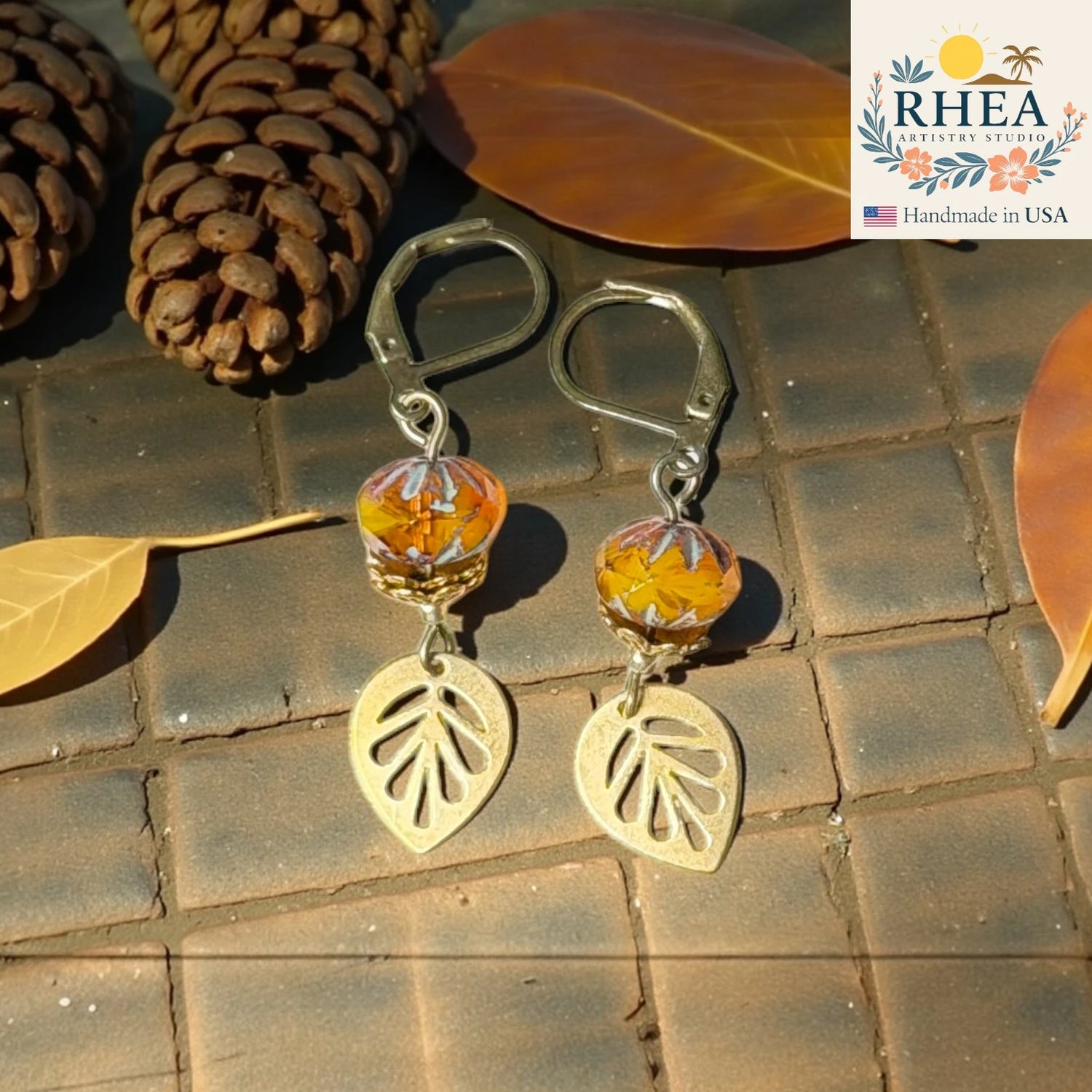 Handcrafted earrings made with premium glass beads and brass accents in amber 
