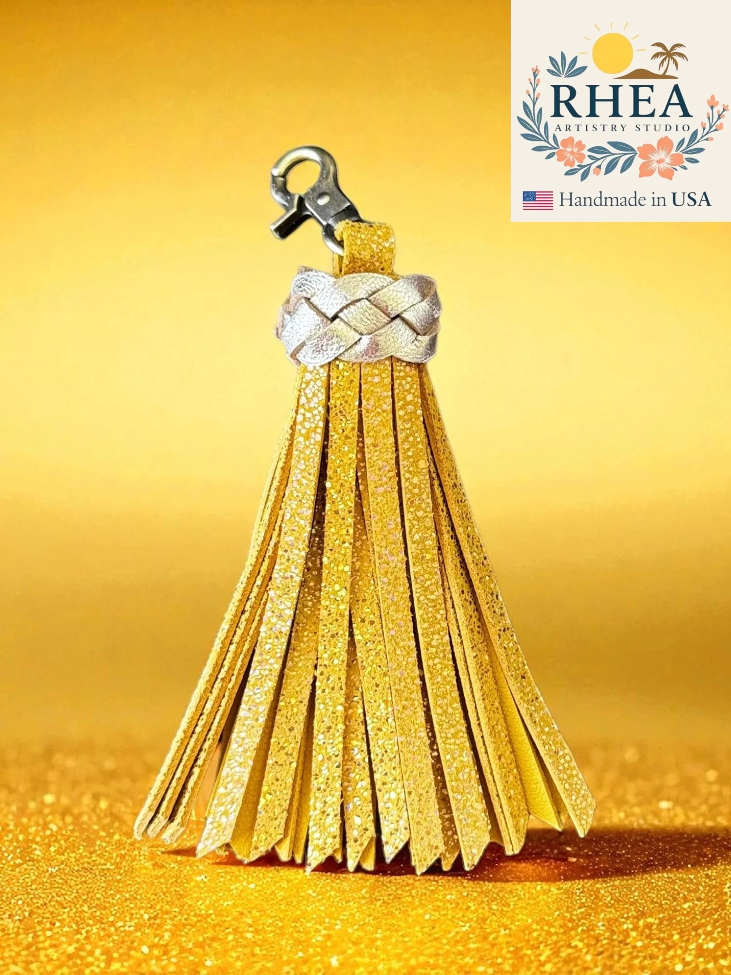 lemon zest tassel keychain with braided design on a yellow background, featuring the RHEA brand.