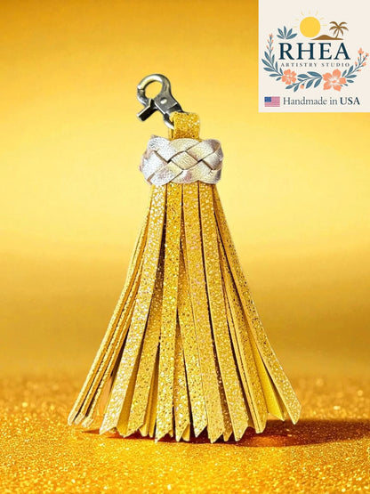 lemon zest tassel keychain with braided design on a yellow background, featuring the RHEA brand.