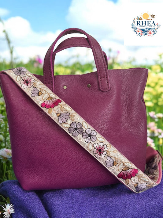 Muted Fuschia pebbled bag with 1.5 wide embroidered strap featuring beige, lavender, pink, white, mustard floral design with vines