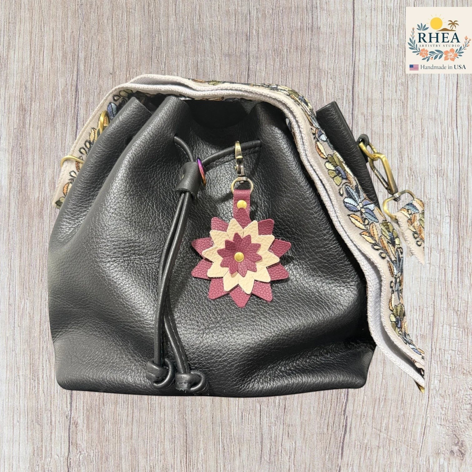 Artisan leather bag charm with multi-layered starflower design