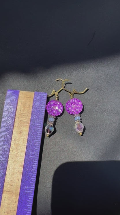 Purple beaded earrings on a black jewelry pouch