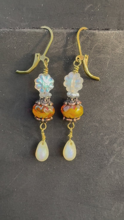 Pair of earrings with colorful beads on a black bag