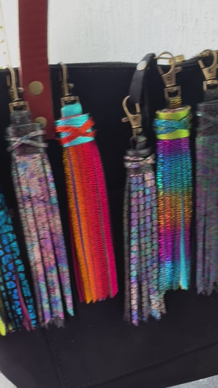 video of a purse with multi colored tassel