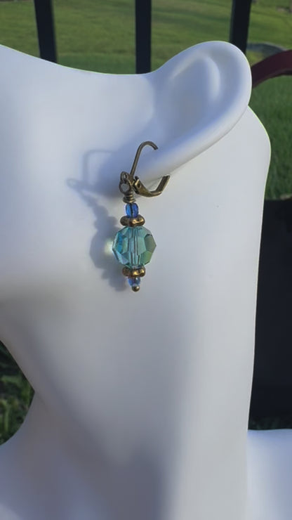Gold and blue beaded earrings on a model