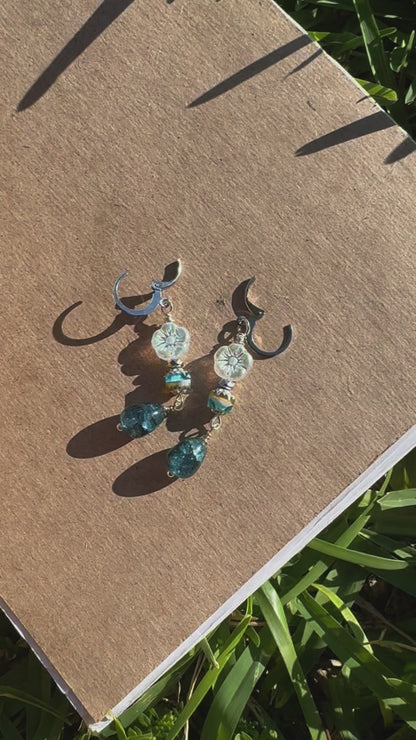 Pair of earrings on a old book