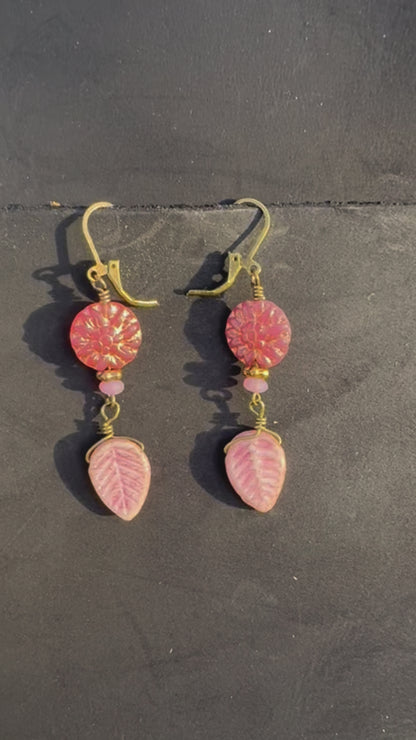 pink dahlia earrings with pink beads on a black bag