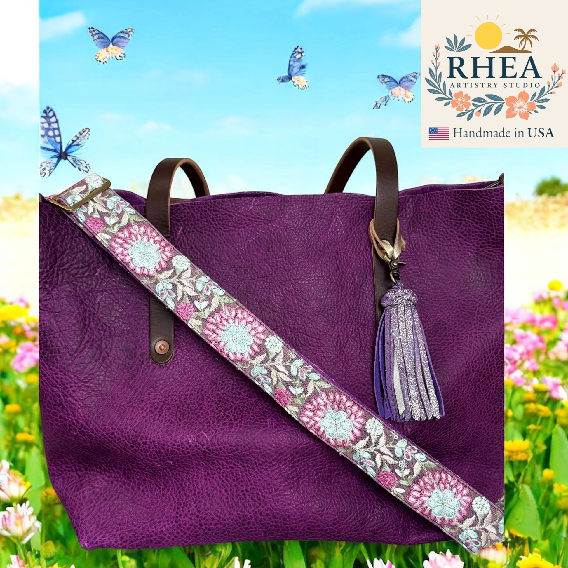 Purple handbag with a floral purse strap and tassel against a colorful background with flowers and butterflies, featuring the RHEA Artistry Studio logo.