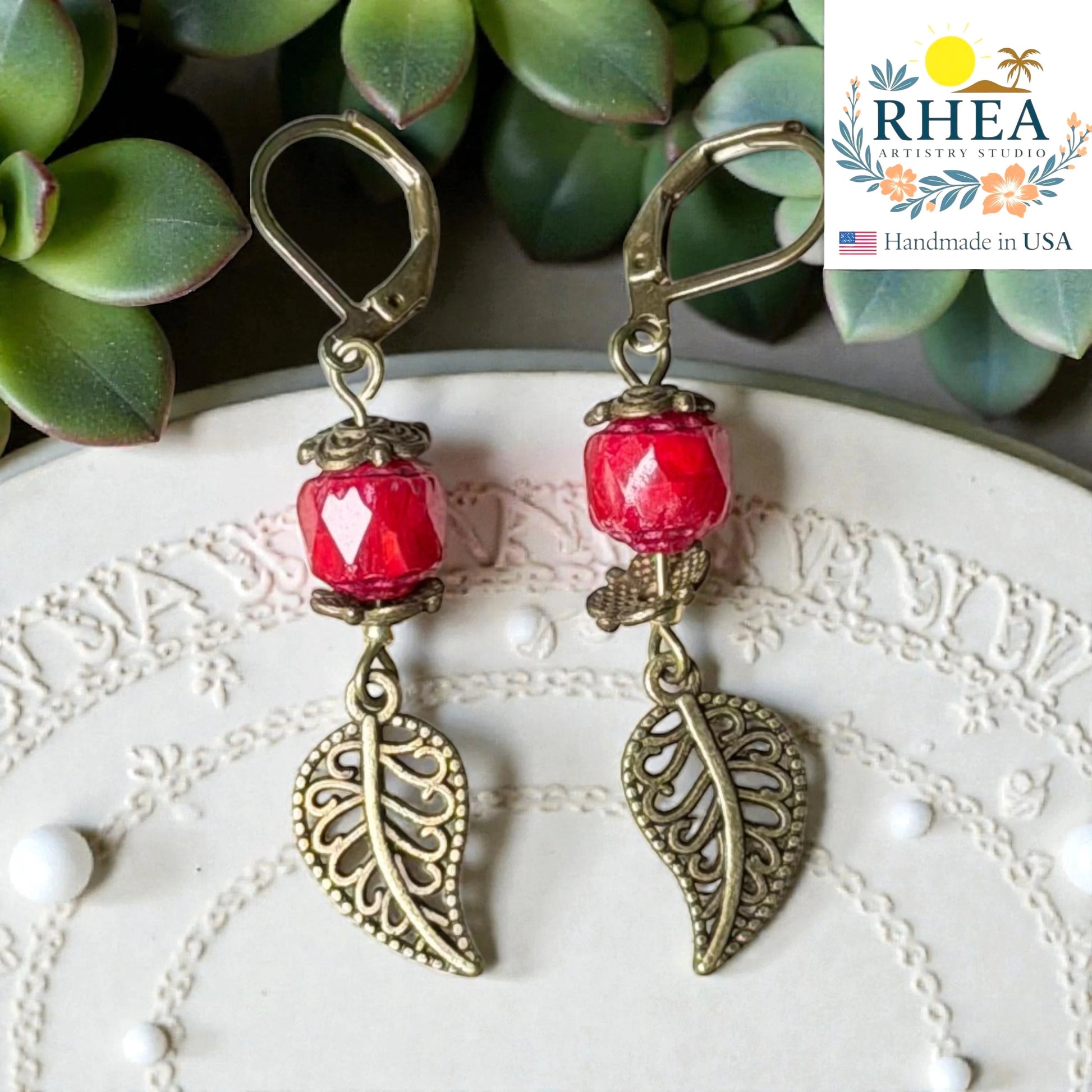 Elegant glass drop earrings with brass leaf detail