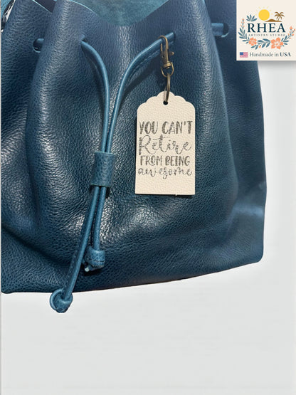 Blue leather bag with a motivational tag and RHEEA brand logo.