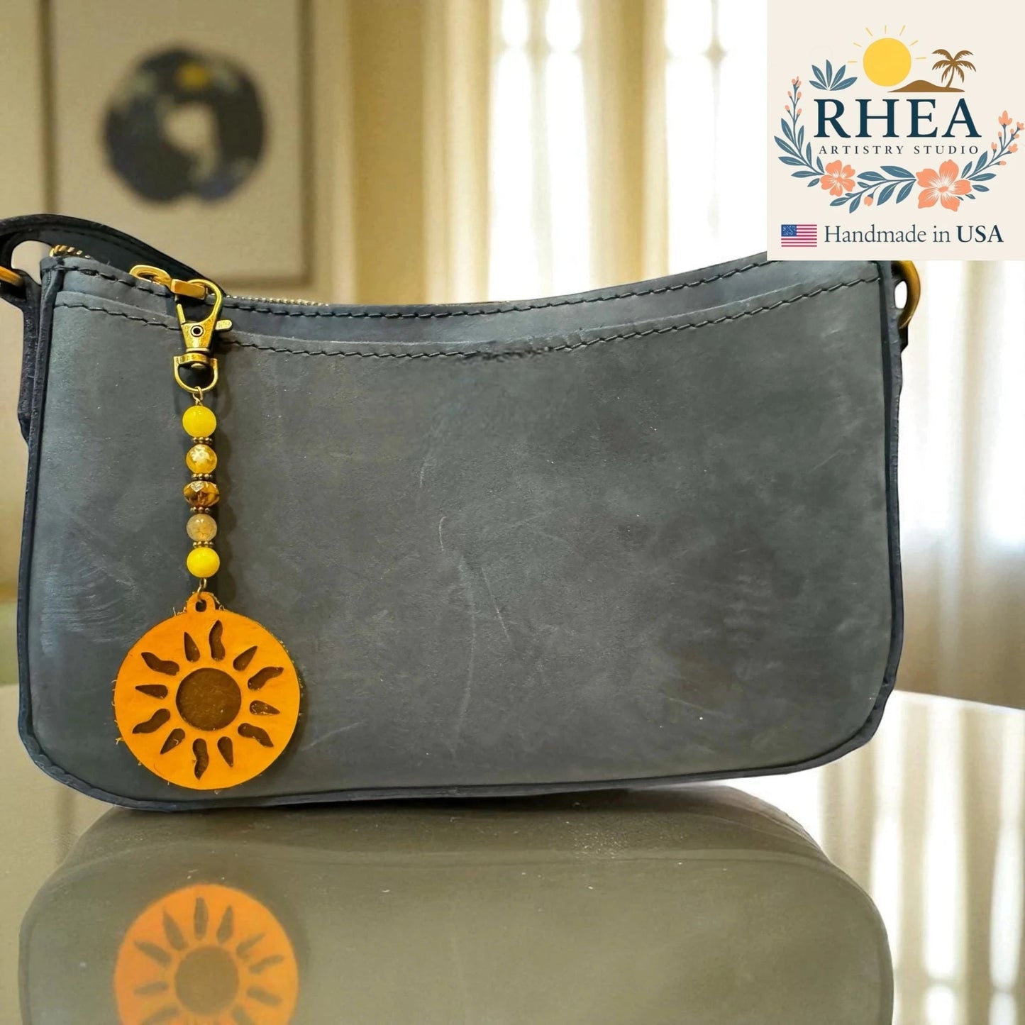 Rhea Artistry Studio handmade beaded bag charm with yellow gemstone beads, Czech glass beads, and a leather sun pendant.