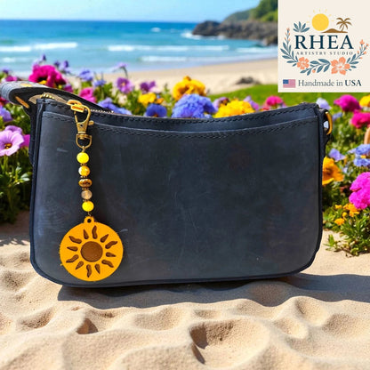 Rhea Artistry Studio handmade beaded bag charm with yellow gemstone beads, Czech glass, and a leather sun pendant.