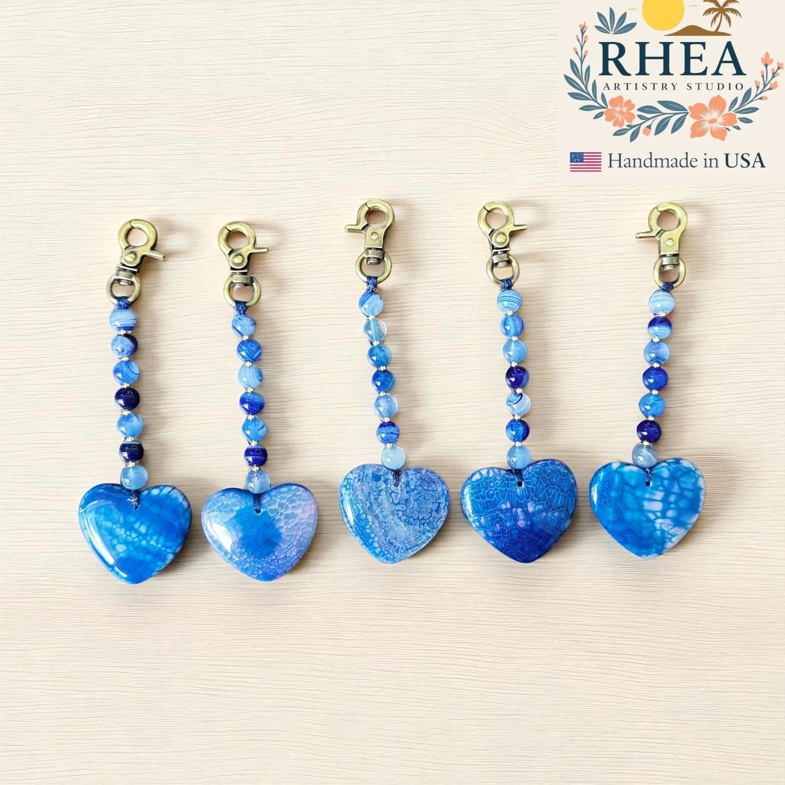 Rhea Artistry Studio blue agate heart bag charm with beaded chain and brushed brass clasp. Handmade gemstone accessory.