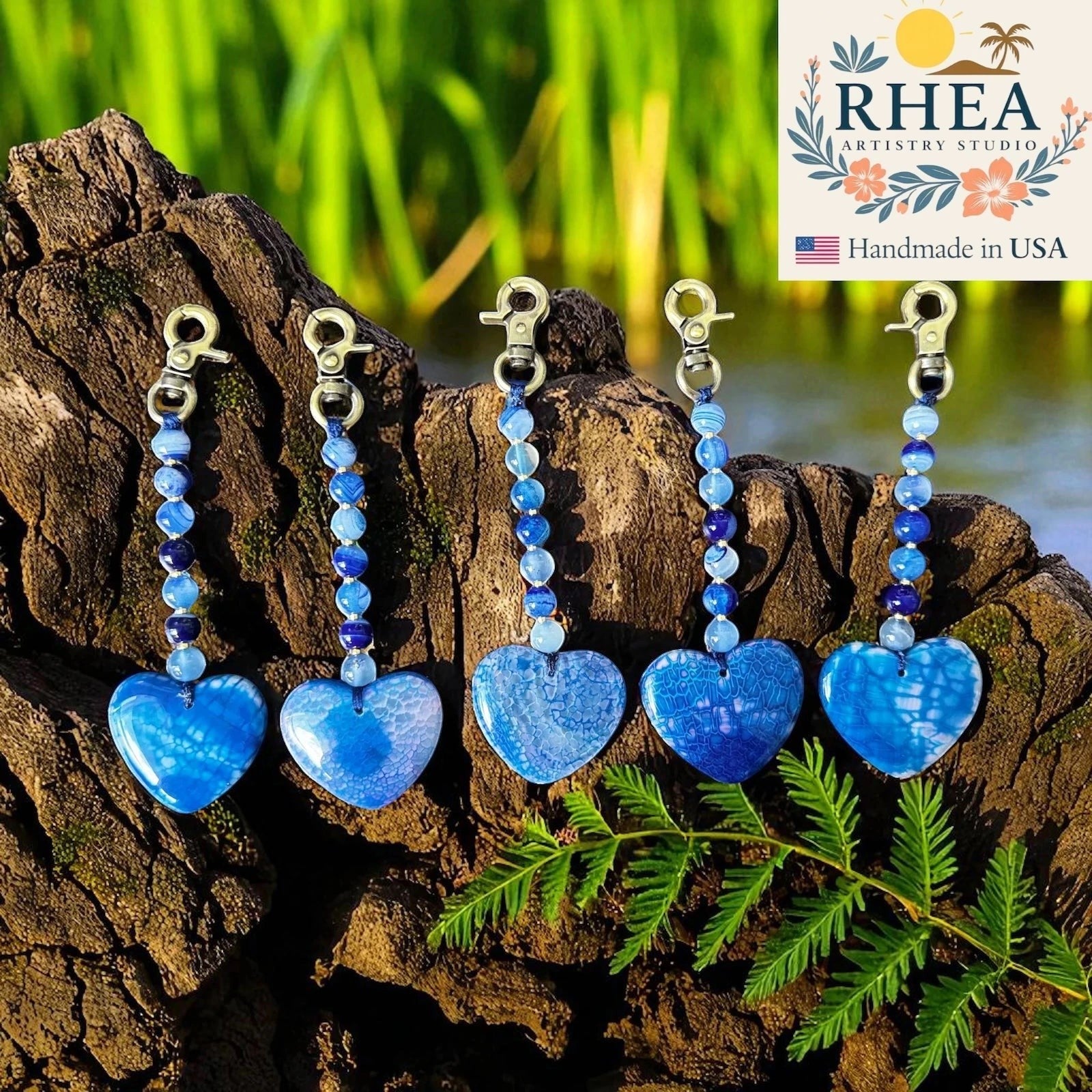 Rhea Artistry Studio blue agate heart bag charms with beaded gemstone accents and brushed brass clasps.