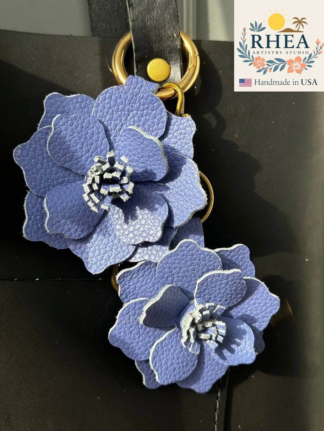 Rhea Artistry Studio blue bell leather flower charm with gold hardware, featuring layered petals and a unique stamen detail.