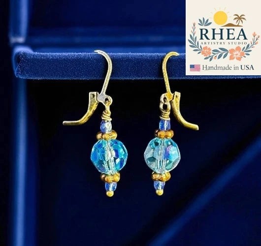 Rhea Artistry Studio handmade blue Czech glass bead earrings with crystal accents and brass hardware, approx. 1.5-2 inches long.