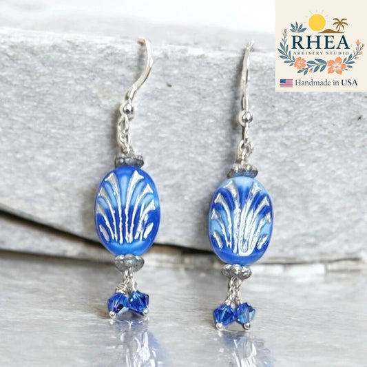 Rhea Artistry Studio coastal blue Czech glass oval beads with silver fan design and Austrian crystals, silver metal hooks.