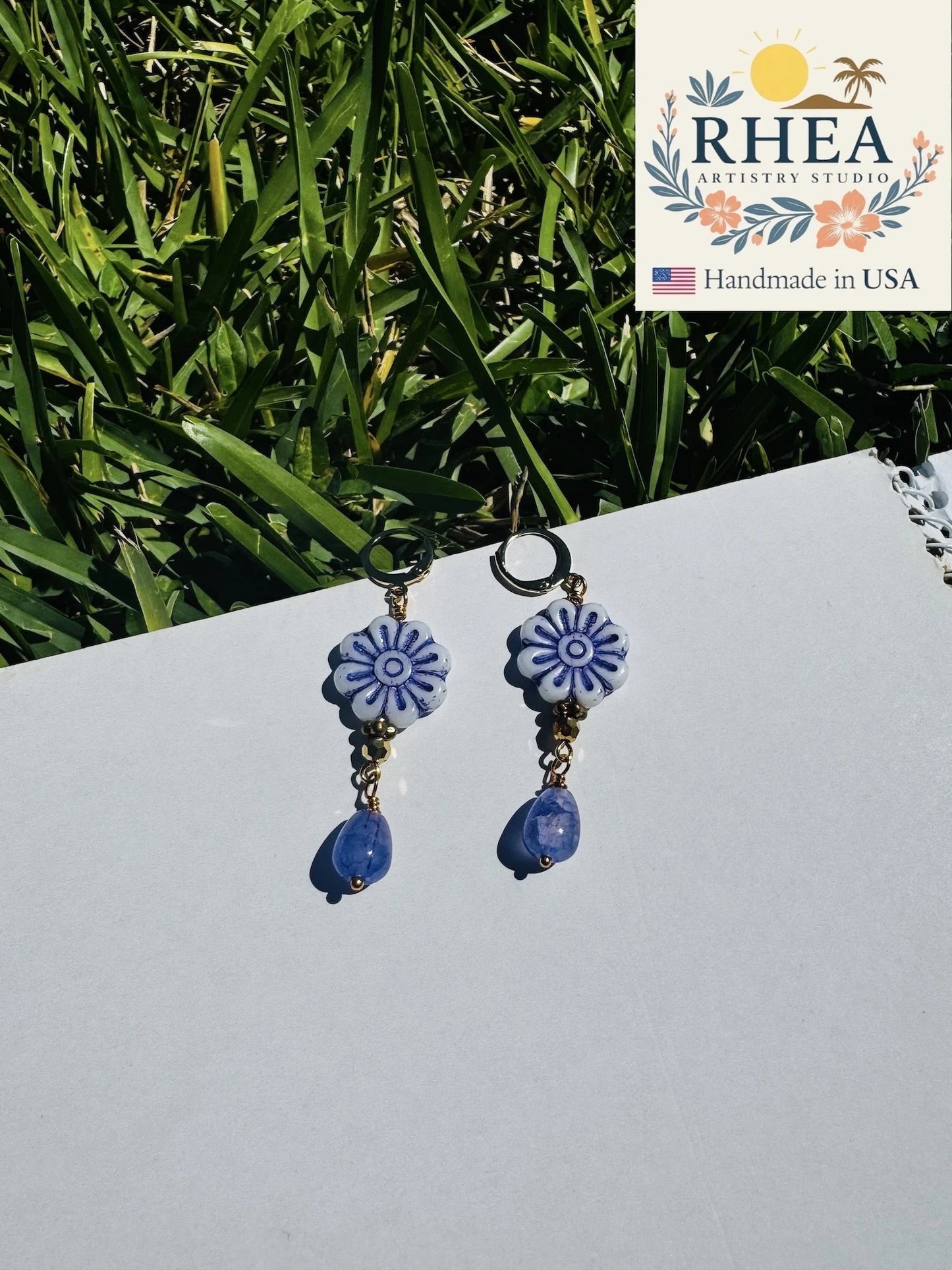 Rhea Artistry Studio blue and white floral Czech glass bead drop earrings with blue gemstone accents and gold plated brass findings.