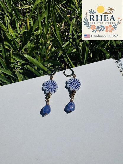 Rhea Artistry Studio blue and white floral Czech glass bead drop earrings with blue gemstone accents and gold plated brass findings.
