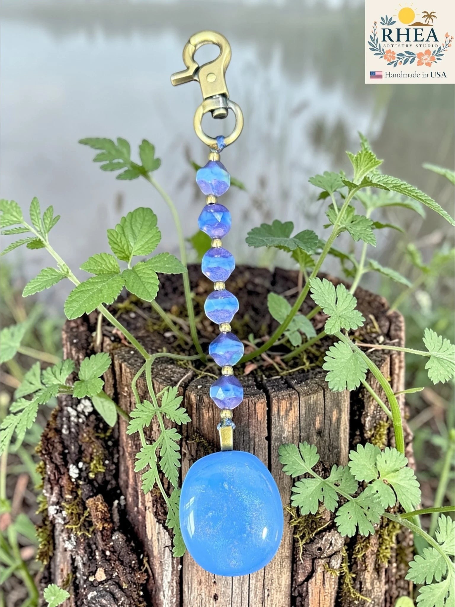 Rhea Artistry Studio blue fused glass pendant bag charm with Czech glass beads and brass accents.