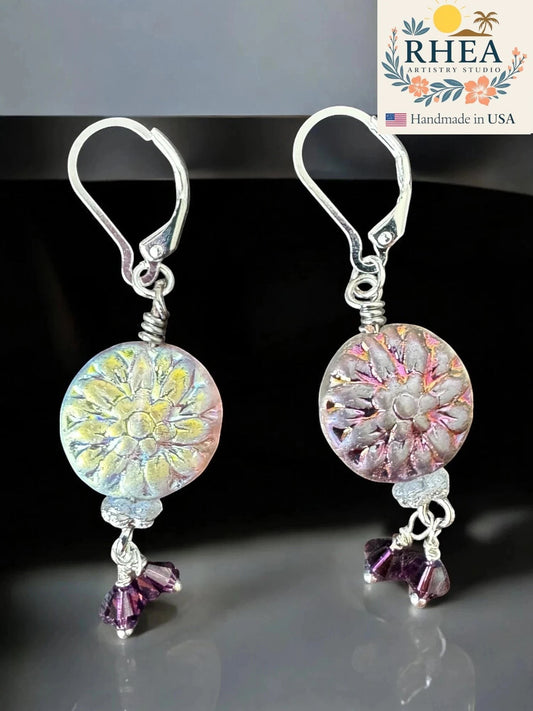 Rhea Artistry Studio Celestial Bloom earrings with iridescent floral coin beads in pastel shifts and plum crystals, silver lever-backs.