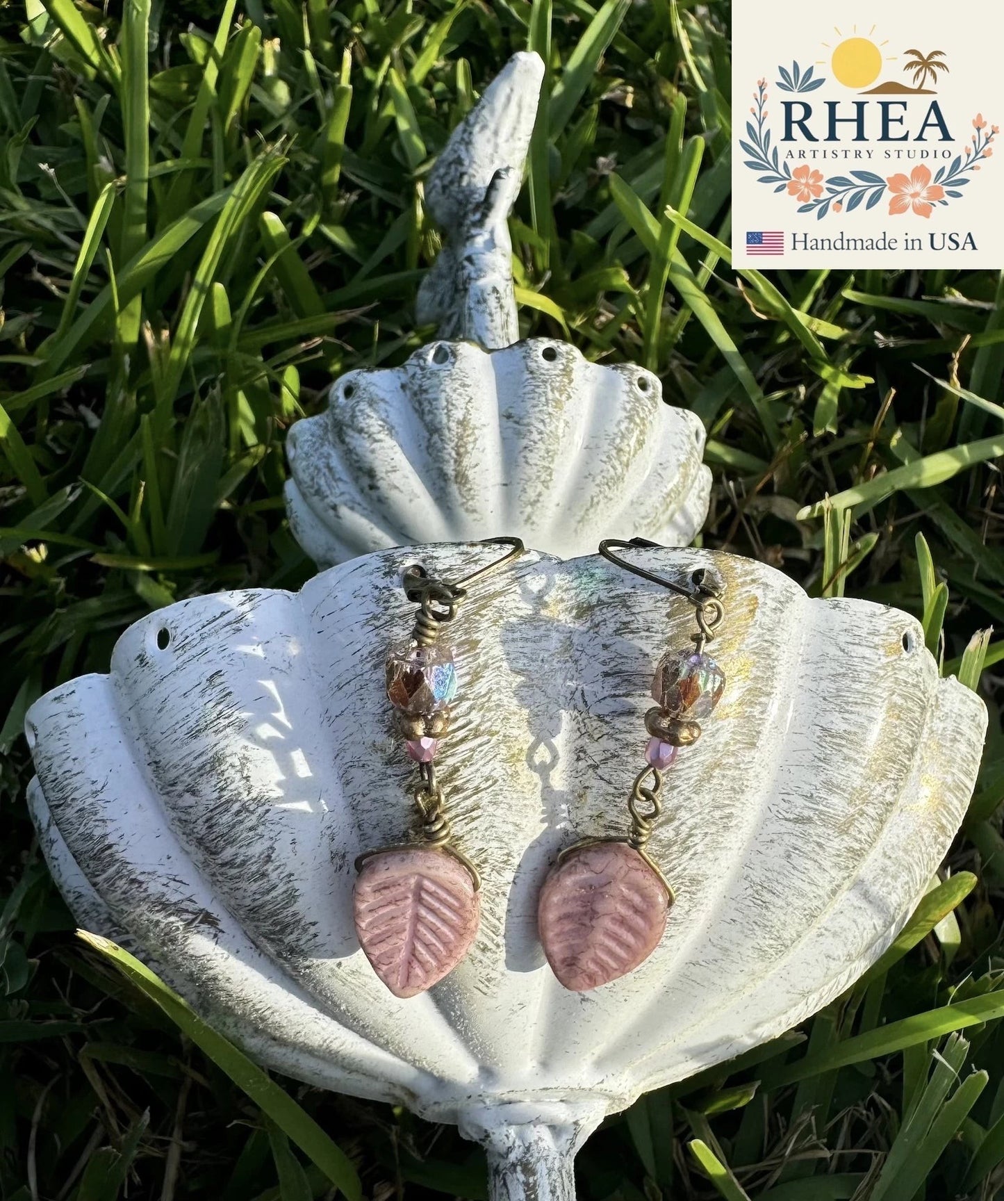 Rhea Artistry Studio Celestial Glow Czech glass earrings with pink leaf beads and iridescent accents, approx. 2 inches long.