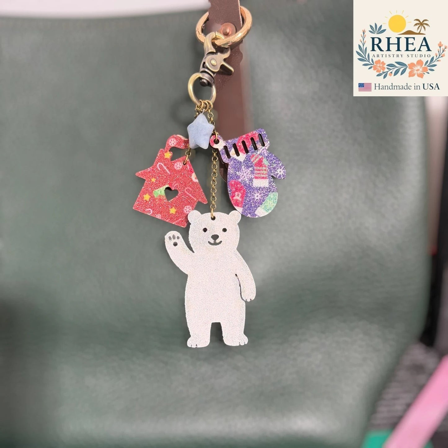 Rhea Artistry Studio handmade leather Christmas charm with polar bear, Christmas tree, and mitten. Antique brass hardware.