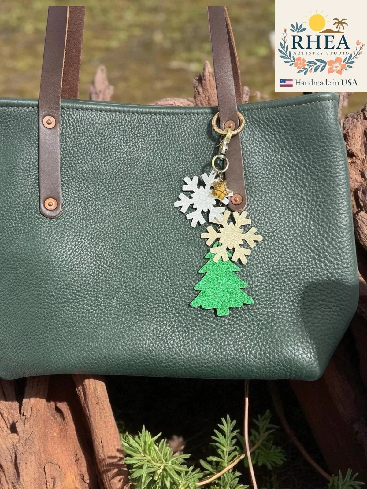Rhea Artistry Studio green leather tote bag with a handmade Christmas charm featuring glittery snowflakes and a Christmas tree.