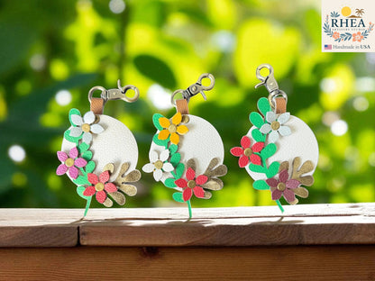 Rhea Artistry Studio Coastal Bloom layered leather floral charm with white base, green leaves, and colorful flowers.
