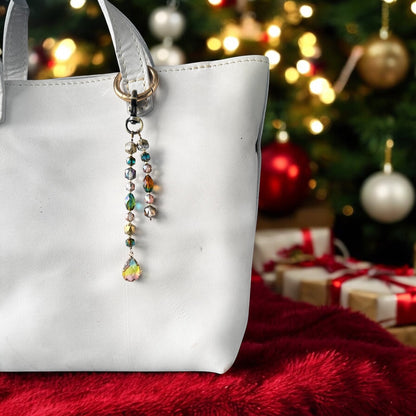 Rhea Artistry Studio elegant crystal beaded keychain with teardrop pendant and brass accents on a white tote bag.