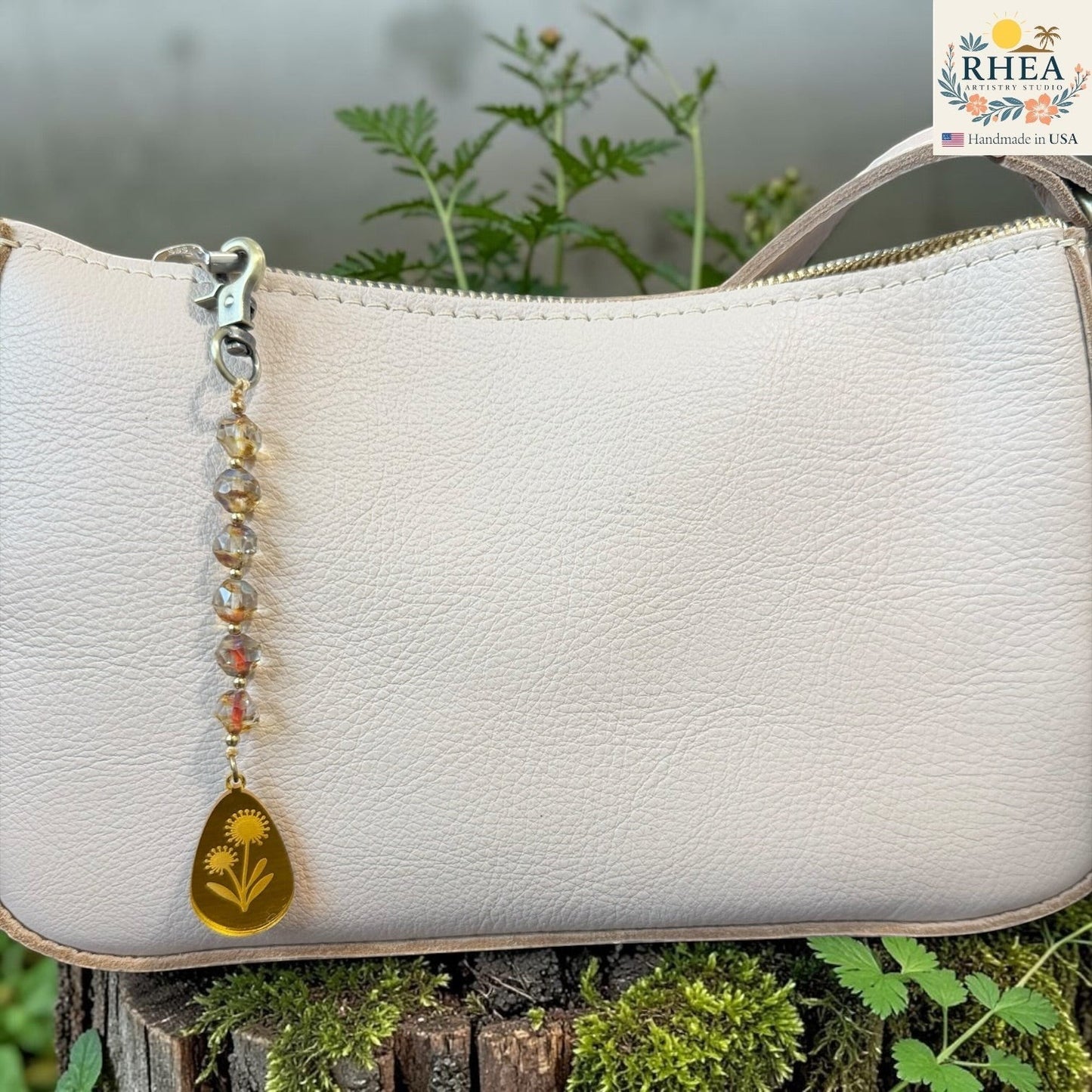 Rhea Artistry Studio artisan bag charm with Czech glass beads, brass accents, and a hand-painted yellow pendant featuring two flowers.