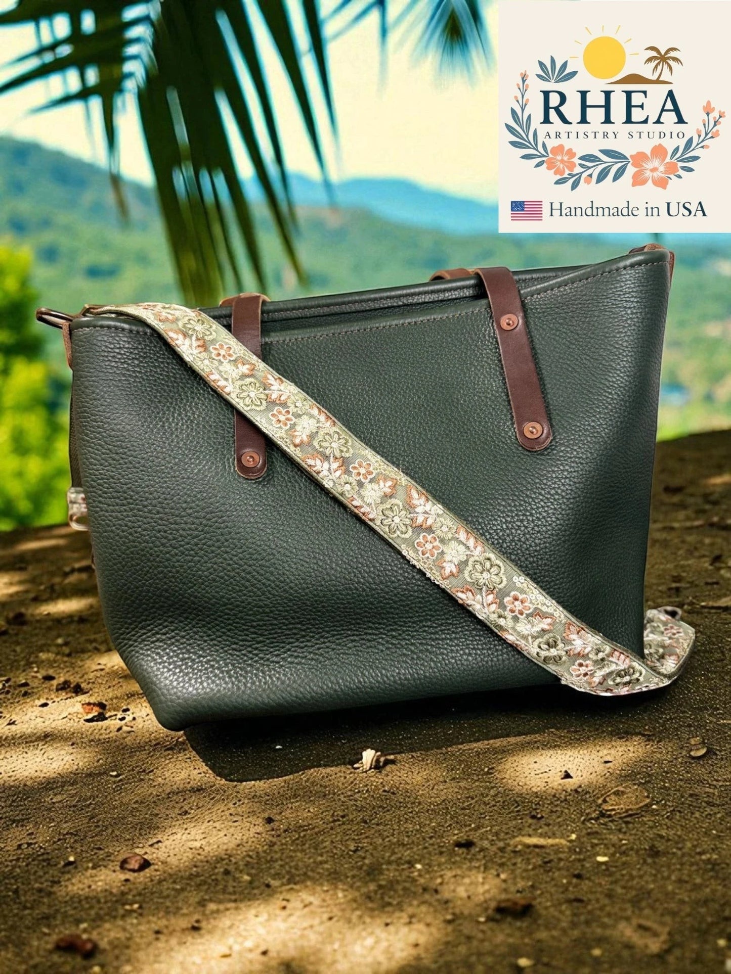 Rhea Artistry Studio dark green pebbled leather tote bag with a 1.5-inch adjustable rosette script embroidered crossbody strap.