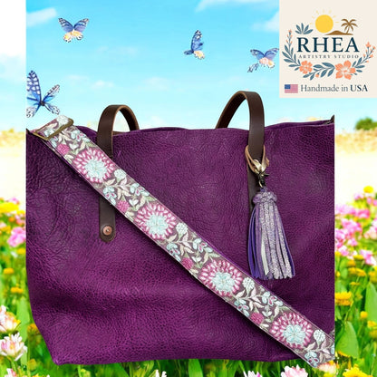 Rhea Artistry Studio purple crossbody strap with frosted pink and silver floral embroidery, adjustable length, brushed brass hardware.