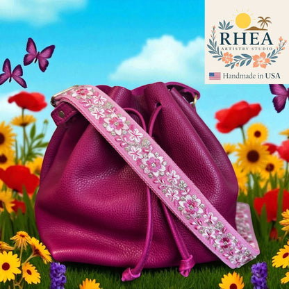 Rhea Artistry Studio 1.5-inch adjustable crossbody strap with pink floral embroidery and brushed brass hardware.