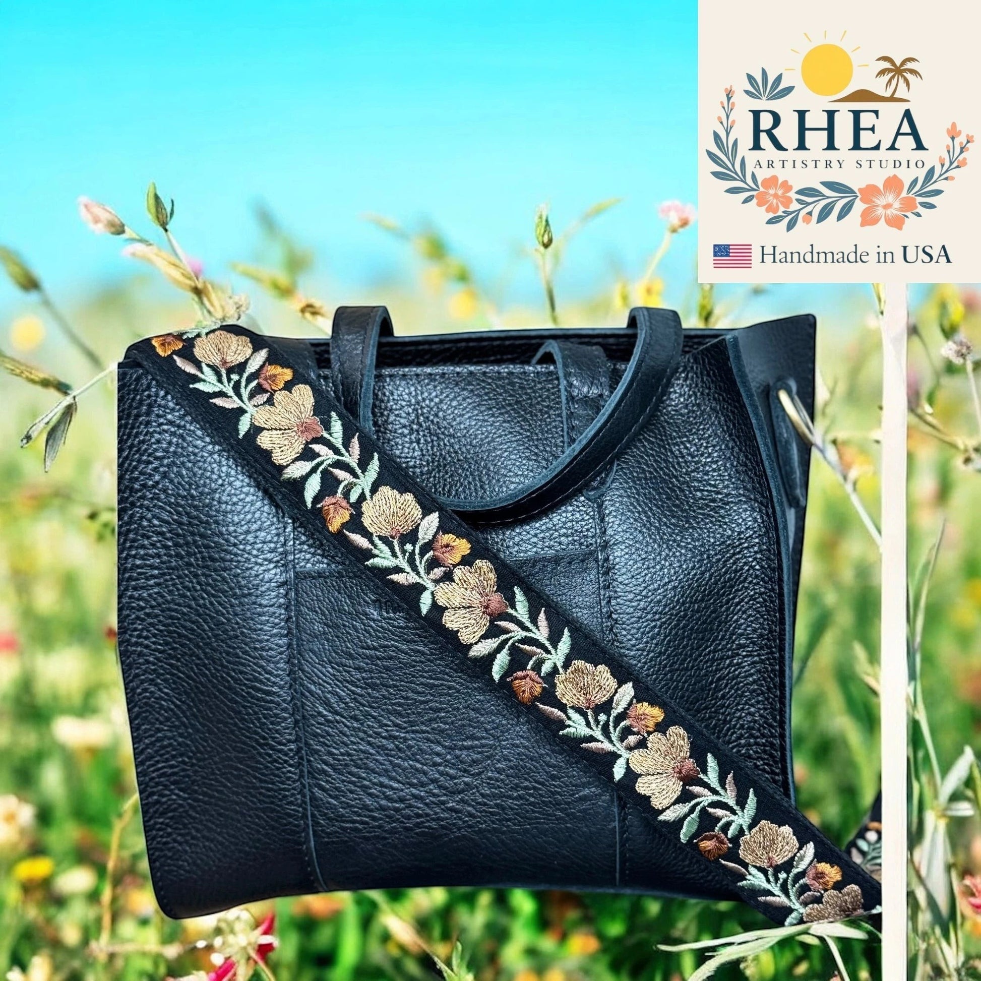 Rhea Artistry Studio black crossbody bag with a 1.5-inch adjustable strap featuring terracotta, sage, and ivory floral embroidery.