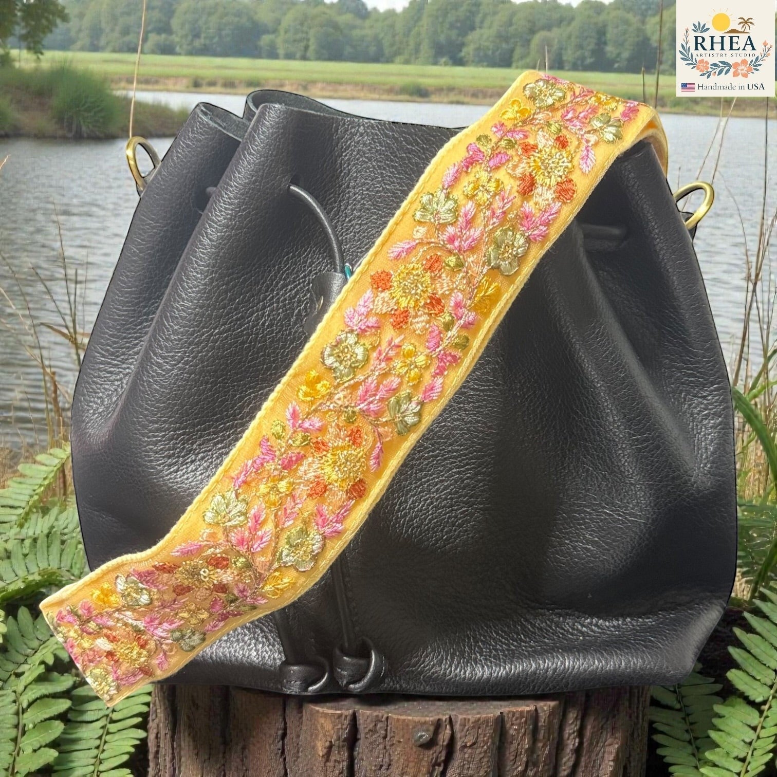 Rhea Artistry Studio yellow crossbody strap with floral embroidery in pink, orange, and gold, backed with cotton webbing.