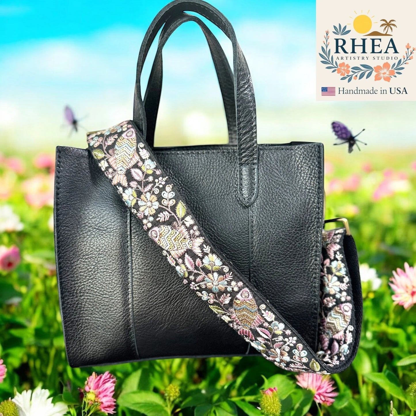 Rhea Artistry Studio 2-inch wide black crossbody bag strap with colorful embroidered fish and floral lace pattern, adjustable with brushed brass hardware.
